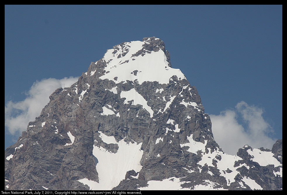 Rocky mountain peak with snow on it.