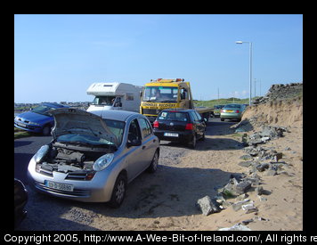 A yellow truck and broken rental car.